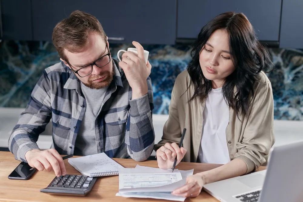 Couple working out whether an annual fee card beats a no fee card on their budget