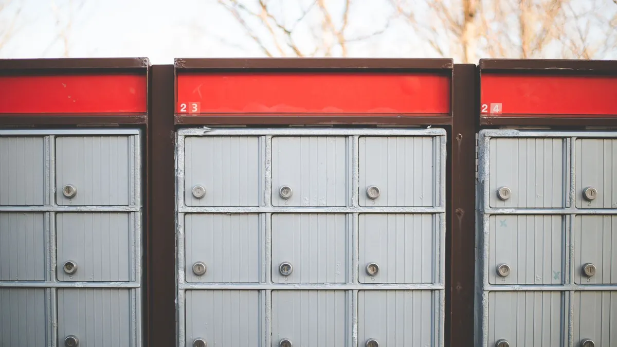 Community mailboxes with red Canada Post panels, one source of the parcel pickups behind a CPC SCP charge